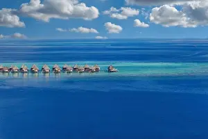 Maldives paradise island. Tropical aerial landscape, seascape with pier, water bungalows villas with amazing sea lagoon beach. Exotic aerial tourism