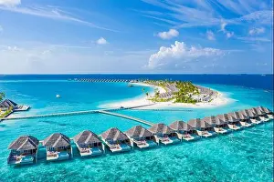 Maldives paradise island. Tropical aerial landscape, seascape with long jetty, water villas with amazing sea and lagoon beach tropical nature. Exotic