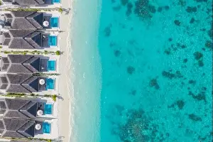Maldives paradise scenery. Tropical aerial landscape, seascape with long jetty, water villas with amazing sea and exotic lagoon beach, tropical nature