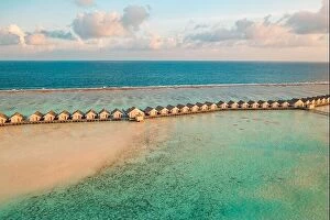 Images Dated 1st February 2022: Maldives sunset paradise. Tropical aerial landscape, seascape with long pier