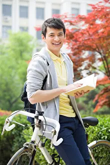 Three Quarter Length Prints: Male college student reading a book