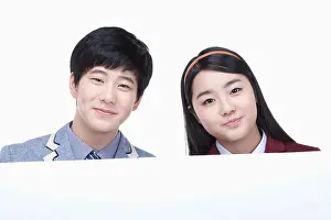 Korean Ethnicity Prints: a male and female students with school uniform holding an empty paper