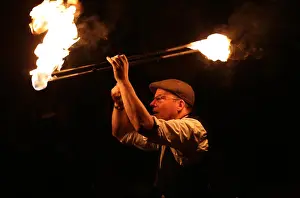 Friedlich Prints: Male fire dancer twirling two large fiery batons overhead