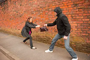 Stalking Prints: Male stalking lone female to steal handbag. Posed by Models. FULLY MODEL RELEASED