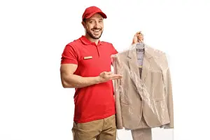 Laundromat Prints: Male worker showing a suit from dry cleaners isolated on a white background