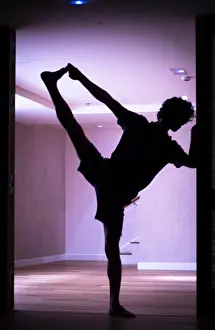 Flexible Prints: Male yoga teacher doing splits leg stretching flexibility calisthenics and yoga asana practice in gym