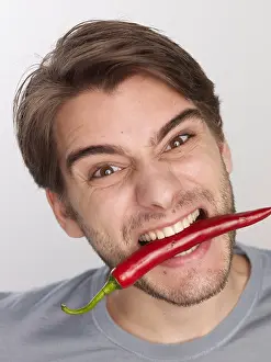 Tasting Prints: Man biting on hot pepper
