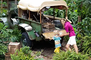 Off Road Prints: Man and child push car stuck in mud in jungle