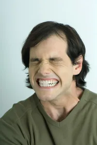 Close Shot Prints: Man closing eyes and clenching teeth, portrait