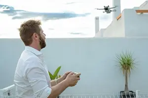 Joystick Prints: Man controlling drone in outdoors image with remote control