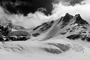 Quiet Prints: Man descending the Gran Paradiso glacier during winter on the north west side