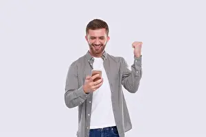 Texting Prints: Man Excited Winning. Man Holding Phone. Winner. Man Won online Casino, Lottery