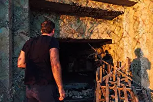 Curiosity Prints: Man explores a dark abandoned Cold War bunker near Ksamil Albania