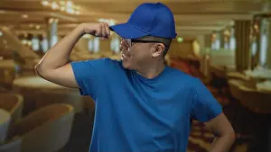 Toned Prints: Man flexes bicep and smiles while wearing blue cap