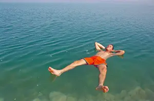 Dead Sea Prints: man floating at the dead sea