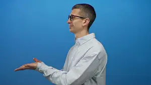 Explaining Prints: Man in glasses smiling against a blue wall