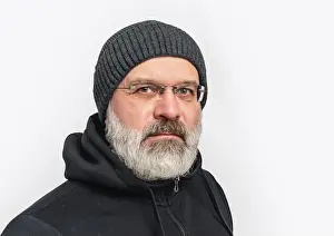 Part Of A Series Prints: Serious man with gray beard and mustache in winter hat