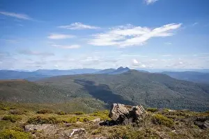 man hiking up a mountain with a backpack, alpine wilderness