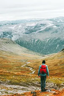 Man hiking trek in mountains with backpack Travel healthy lifestyle concept active weekend summer vacations