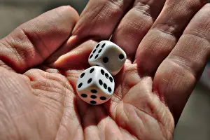 Board Game Prints: Man holding 2 black and white dice