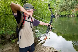 Firing Prints: man hunting fish with bow and arrow attached to string