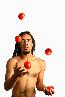 Throw Prints: Man juggling tomatoes cut out on white background