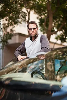 Appreciating Prints: Man leaning on sports car