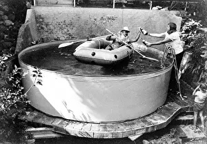 Comical Prints: Man with lifejacket in inflatable dinghy in paddling pool, Mexico City, Mexico