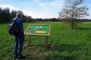 Walkers Prints: Man looking at information board in Sanitorium Park, Leckwith, Cardiff South Wales, 2023