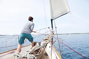 Weekend Activities Prints: Man pulling on rope on yacht