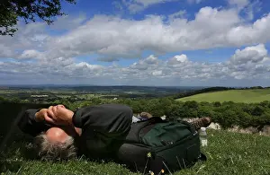 Rolling Hills Prints: Man relaxing in summer sunshine