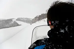 Snowmobile Prints: A man rides a snowmobile tour at Hanazono resort in Niseko, Hokkaido, northern Japan