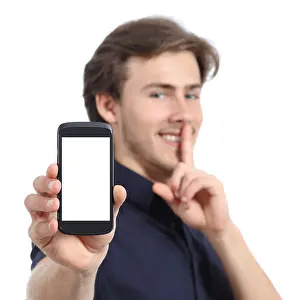Silent Prints: Man showing mobile phone screen and asking for silence isolated on a white background