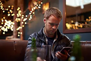 Texting Prints: Man Sitting Inside Cafe Sending Text Message