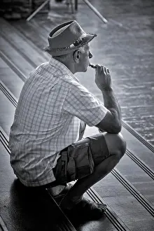 Contentment Prints: Man sitting alone and smoking an e-cigarette. Black and white photography