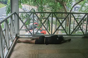 Asleep Prints: Man sleeping on the footpath in Kuala Lumpur, Malaysia