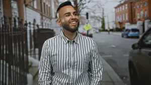 Earrings Prints: Man smiling with head tilted back on city street