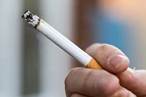 Tobacco Prints: Man smoking a king size cigarette, with ash and smoke