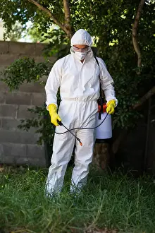 Sprayer Prints: Man spraying pesticide on grass