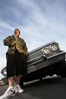 25 30 Years Prints: Man standing in front of car low angle view