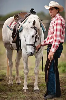 Hoof Prints: Man standing beside horse