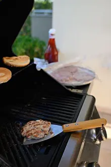 Food Preparation Prints: A man is standing near the grill on a terrace, grilling meat