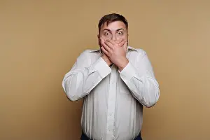 Shocked Prints: A man stands against a simple beige backdrop