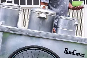 man street food seller serving the indonesian traditional green bean porridge on his silver cart