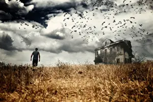 Nightmare Prints: Man walking in a field towards a haunted house