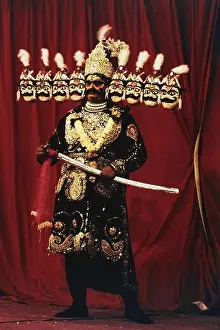 Masks Prints: Man wearing ten faces masks of Ravana costume during Ramayan stage performance