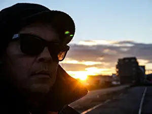 Backlit Prints: a man wearing a hat and sunglasses during sunset
