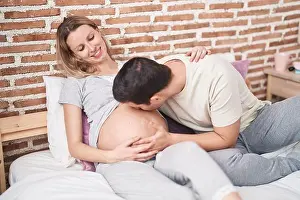 Awake Prints: Man and woman couple kissing belly sitting on bed at bedroom