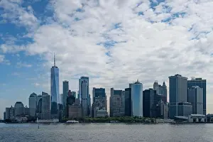 City Landscape Prints: The Manhattan skyline as viewed from the sea, on a partially cloudy day