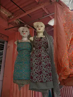 Sari Prints: Mannequin models with painted makeup wear beautiful sari fabric dresses hanging outside a shop